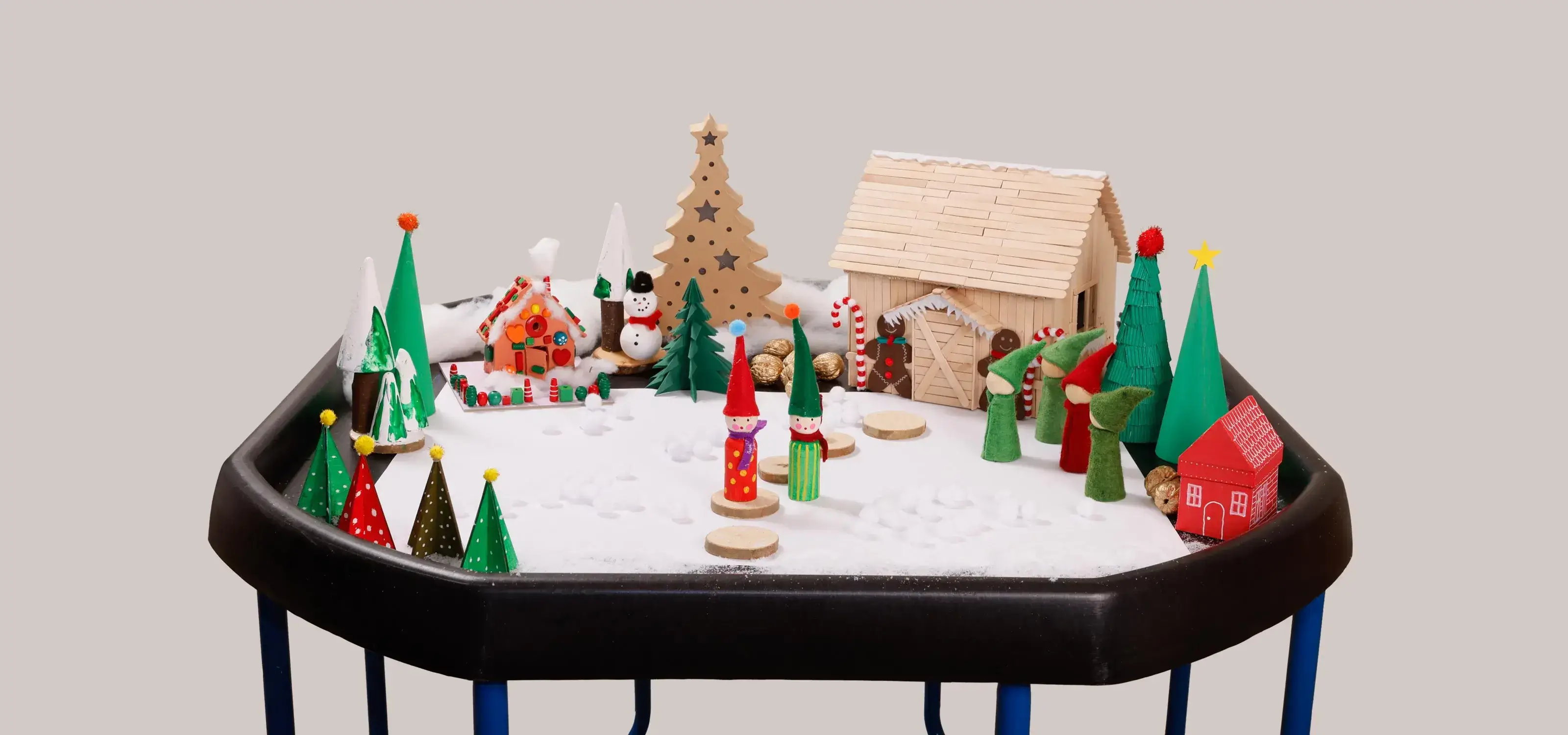 Thementisch zum Thema Weihnachtswunderland mit Spielfiguren und selbst gebasteltem Lebkuchenhäuschen